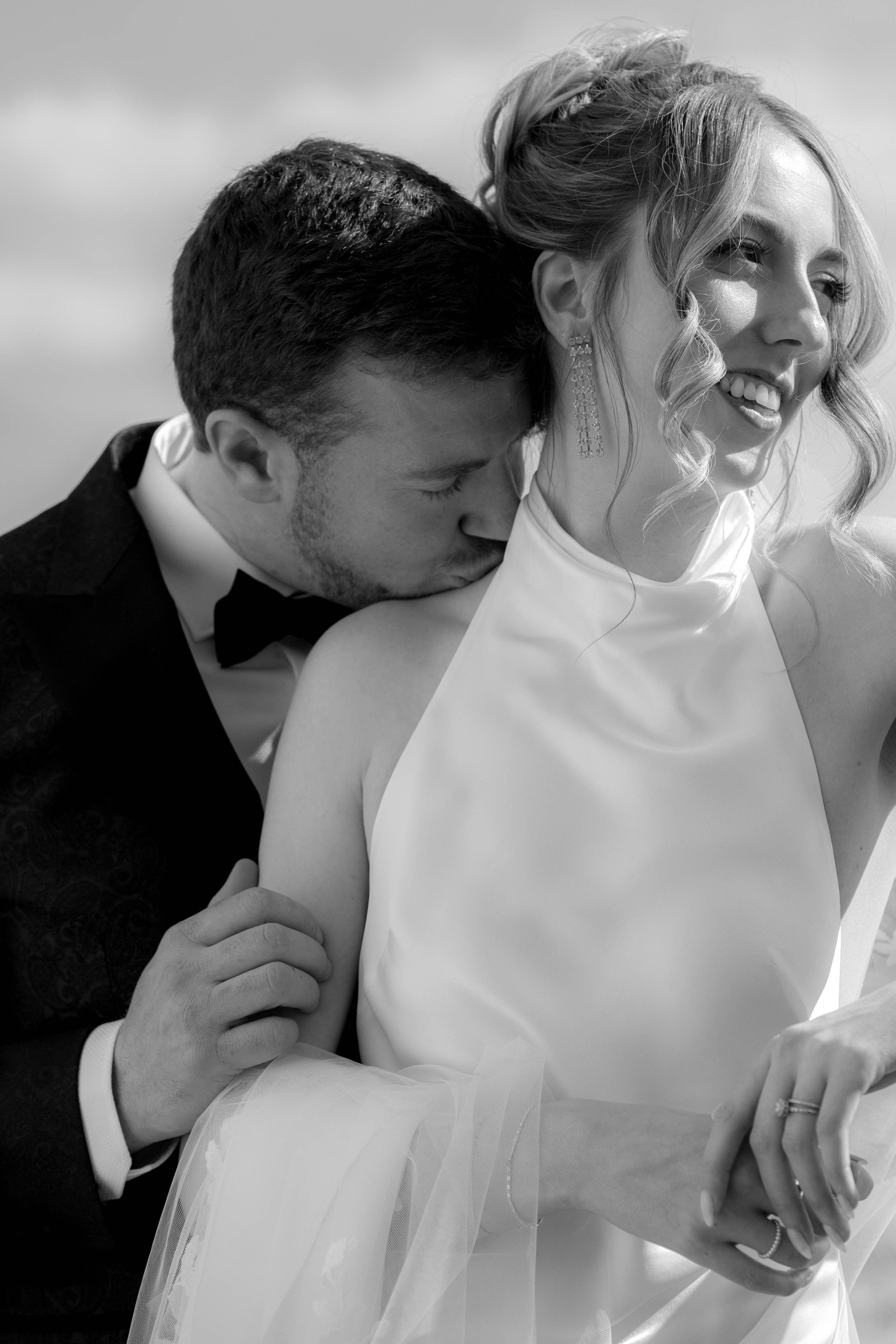Black and white portrait of tender romantic moment between bride and groom.