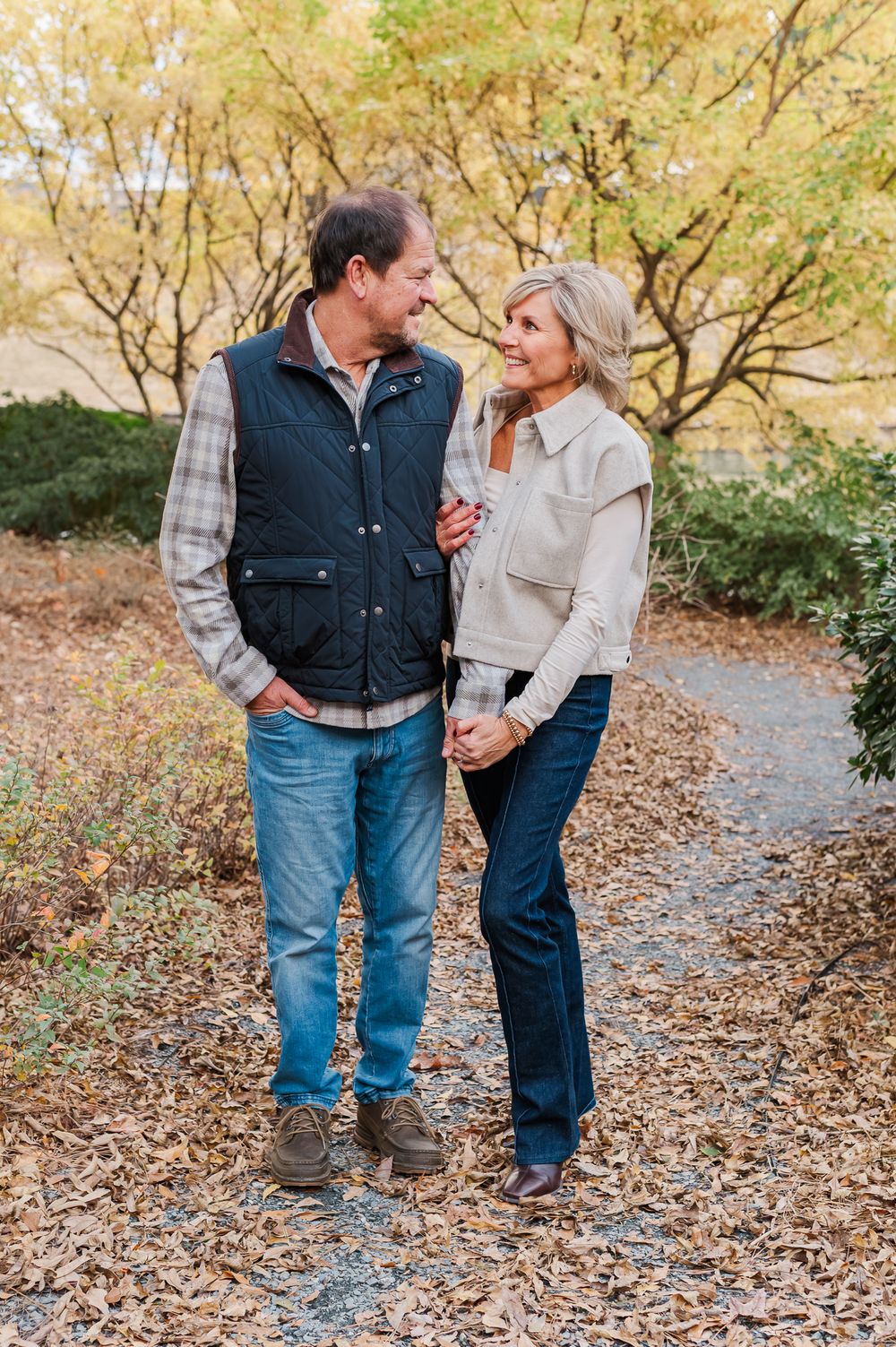 Couple posing by fall foliage in Fayetteville, GA