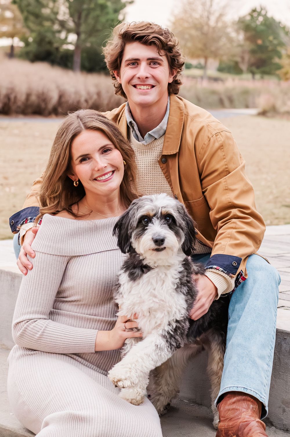 Male and female couple with dog posing on the stairs, Fayetteville, GA