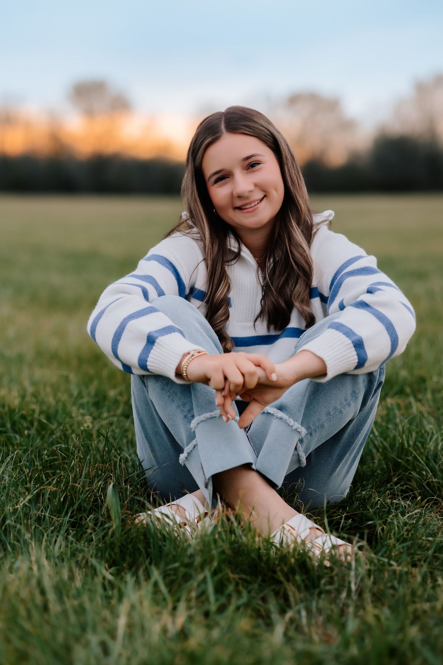 Lonoke Family Photos in Lonoke County, Arkansas- teen girl sitting in a field at sunset
