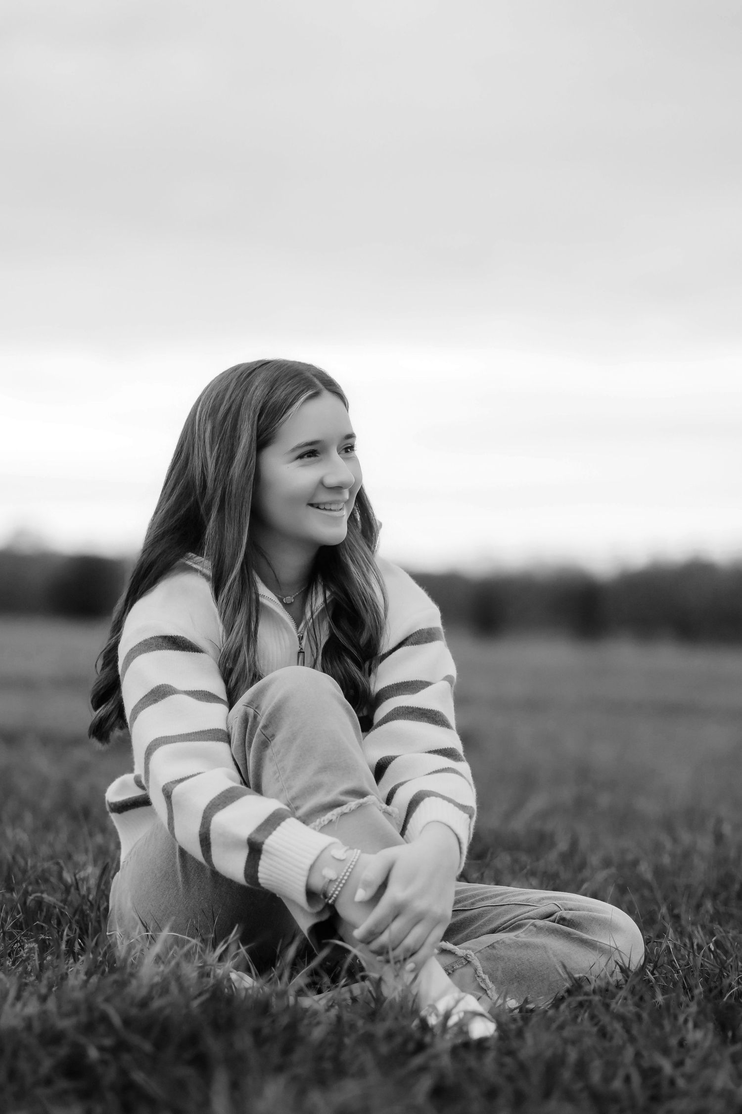 Lonoke Family Photos in Lonoke County, Arkansas teen girl sitting in a field at sunset