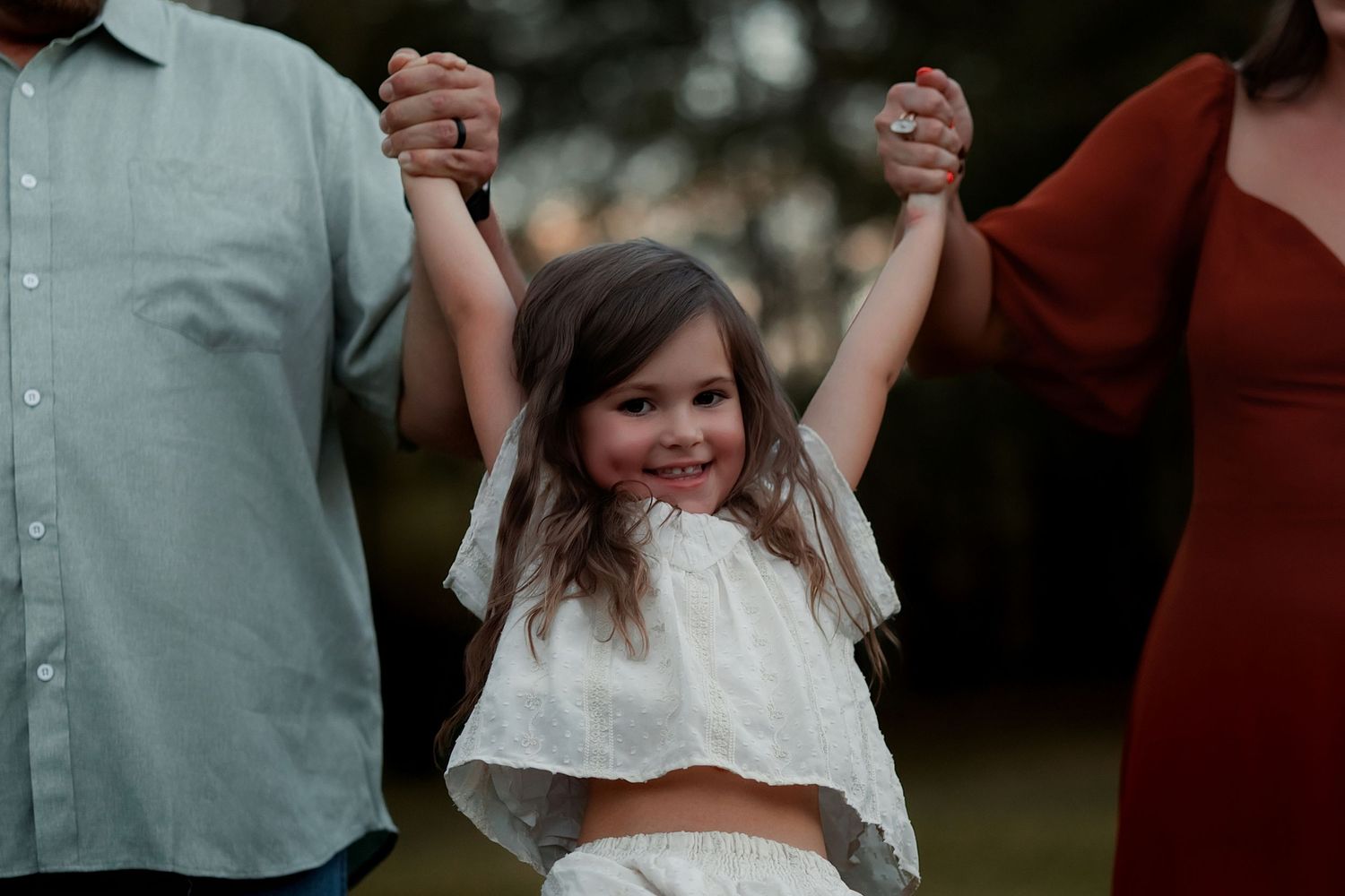 Beebe Arkansas Family pictures in Jacksonville, Arkansas- parents swinging toddler girl