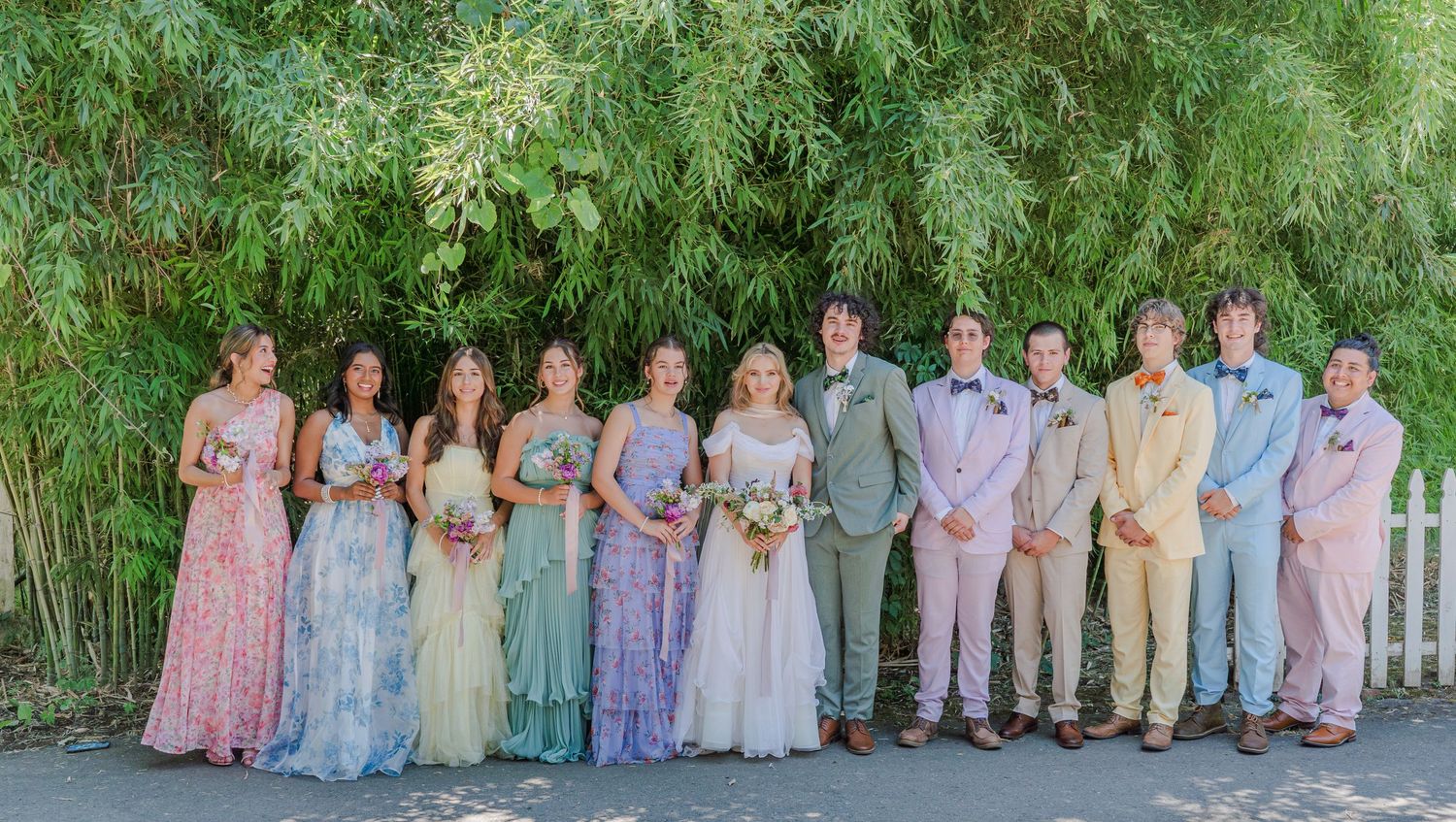 A joyful photo of the bride and her bridesmaids, and the groom with his groomsmen, celebrating with laughter and love on the wedding day.