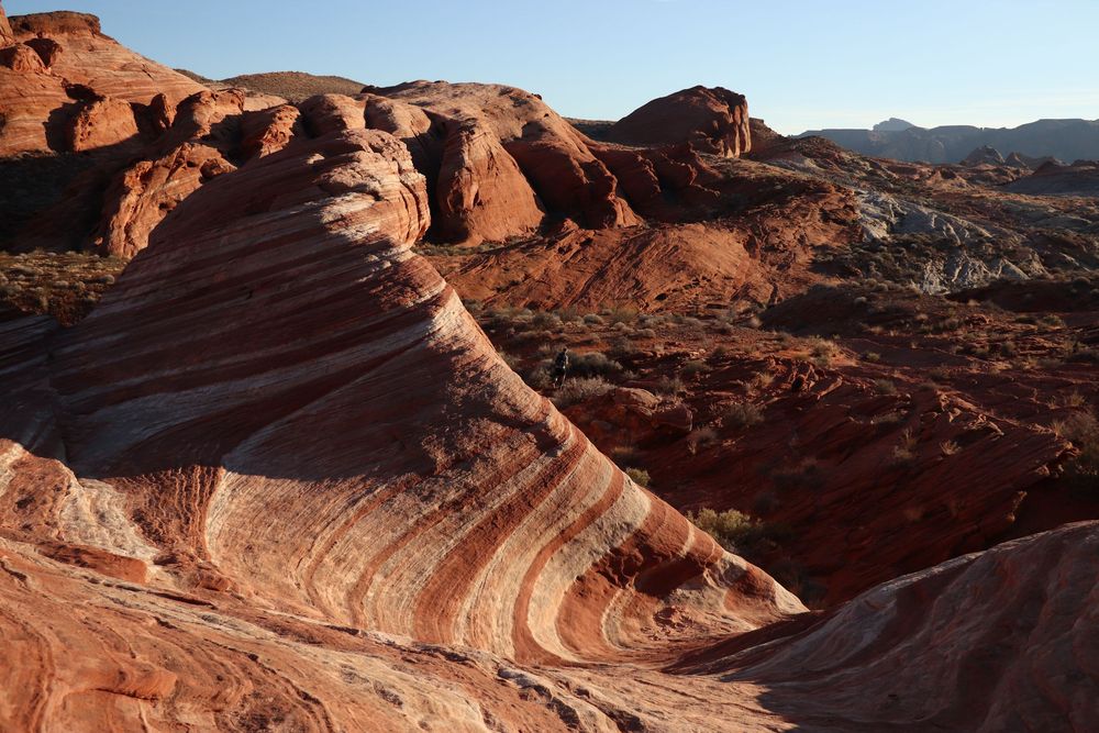 Colorful layered red and orange sandstone rock formations in Valley of Fire Nevada desert.