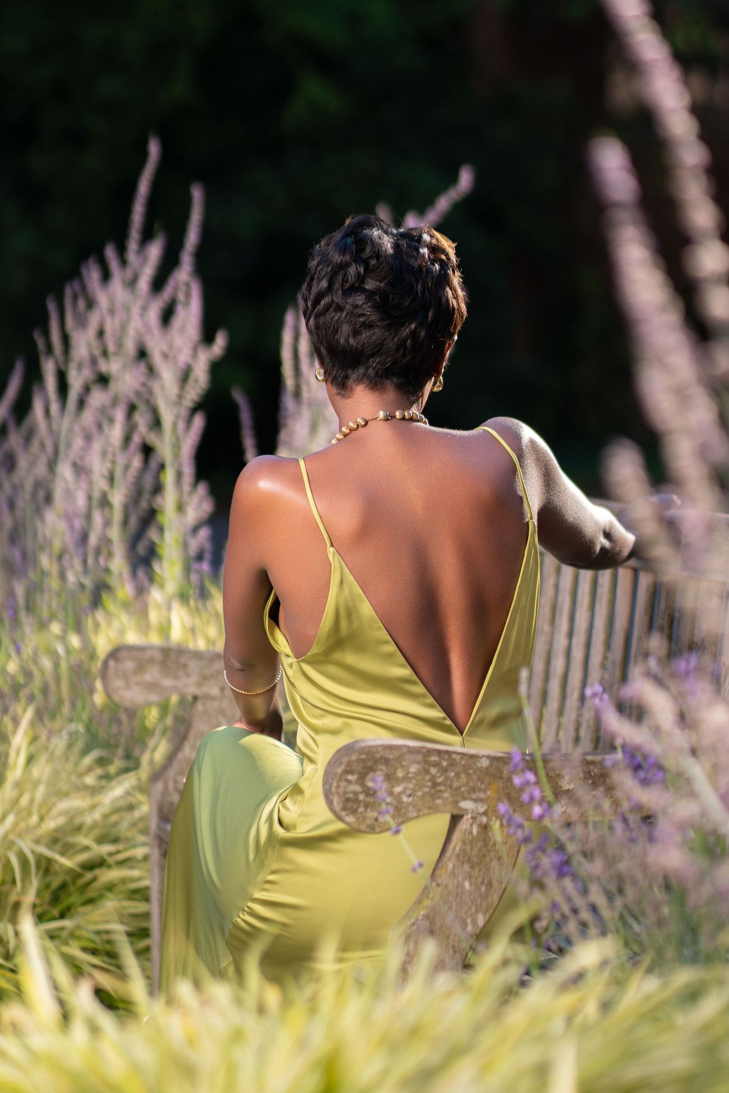 Back view of lime dress against garden setting with lavender and natural lighting.