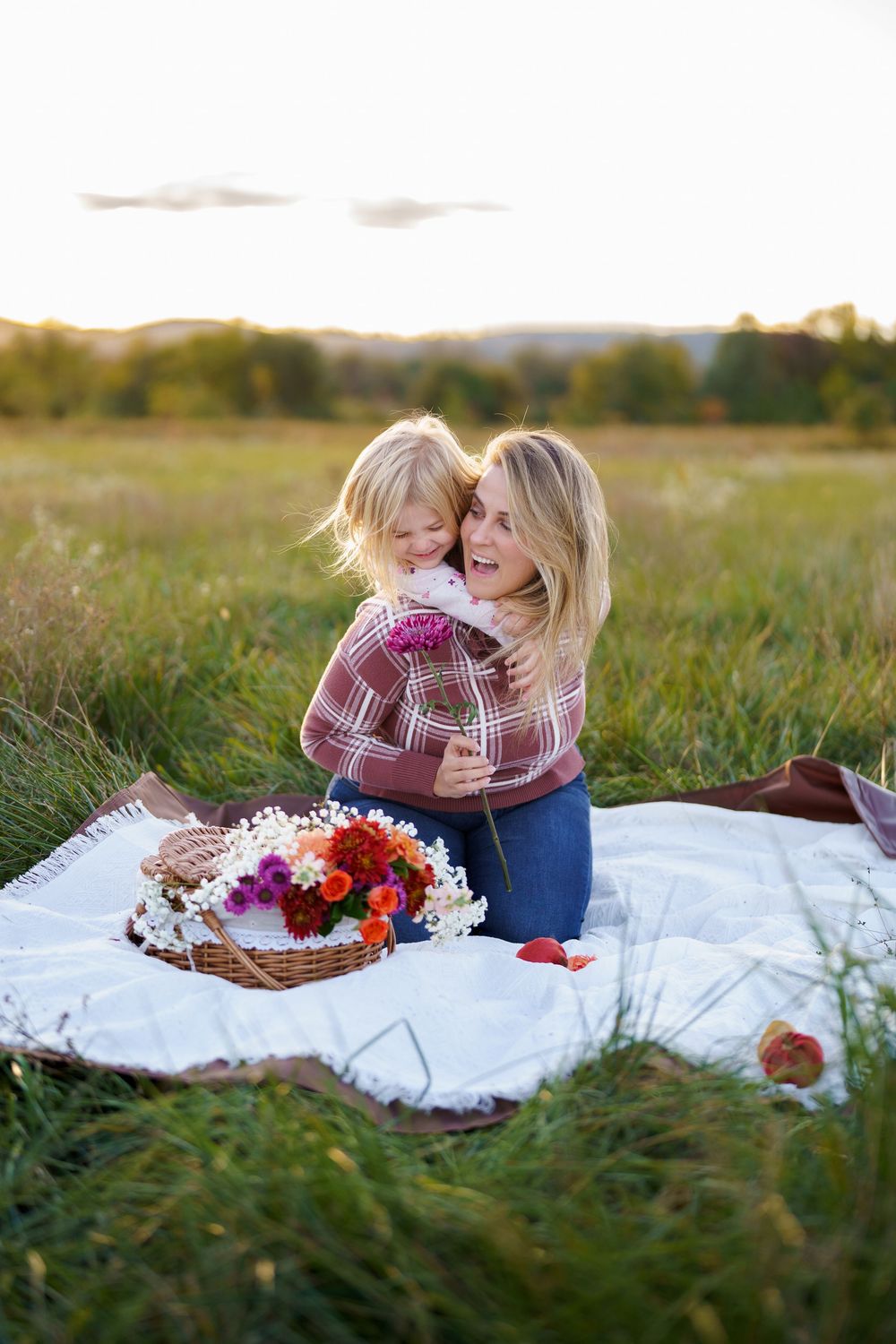 mother and daughter having fun in a field in Frederick, MD