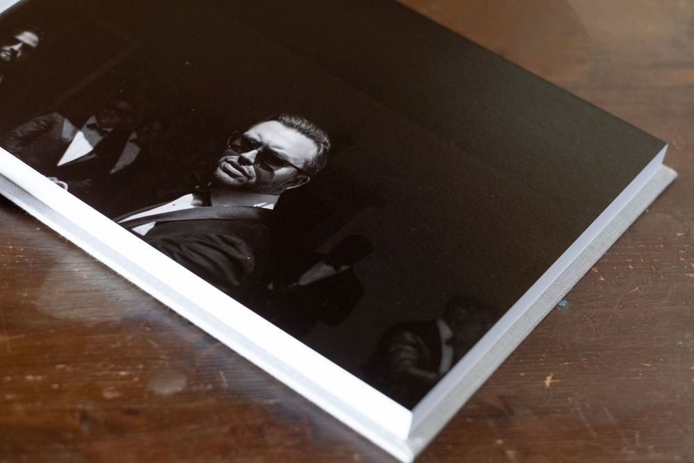 A series of vintage black and white polaroid photographs arranged in a row on a wooden surface.