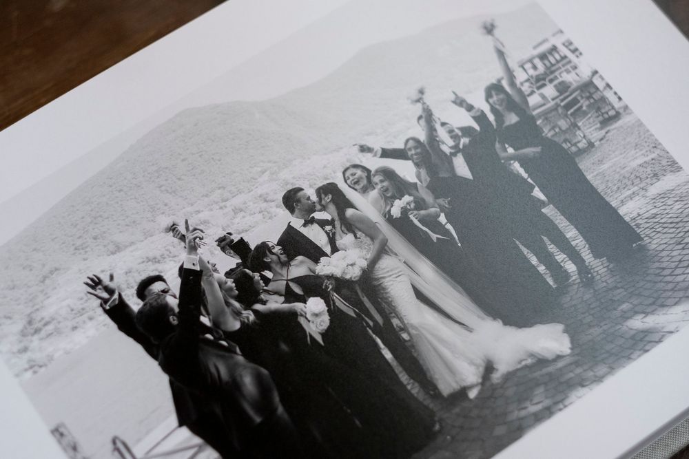 A collection of vintage black and white photographs laid out in a row showing people at leisure by the water.