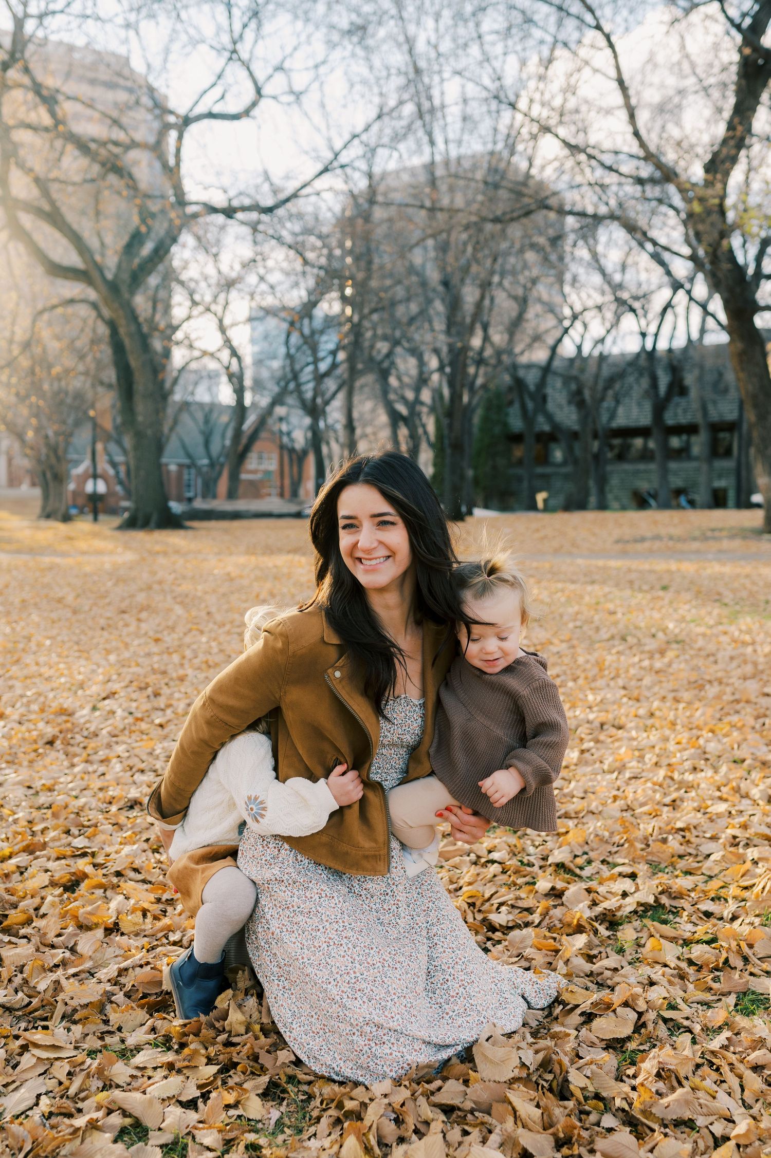 A joyful autumn scene with fallen leaves on the ground.