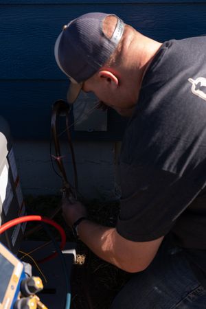 Close-up shot of maintenance work being performed in dark lighting conditions.