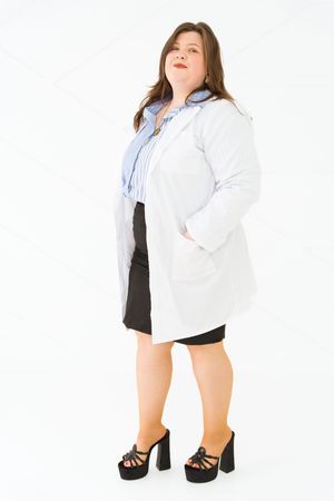 Person in white lab coat and black dress poses against white background.
