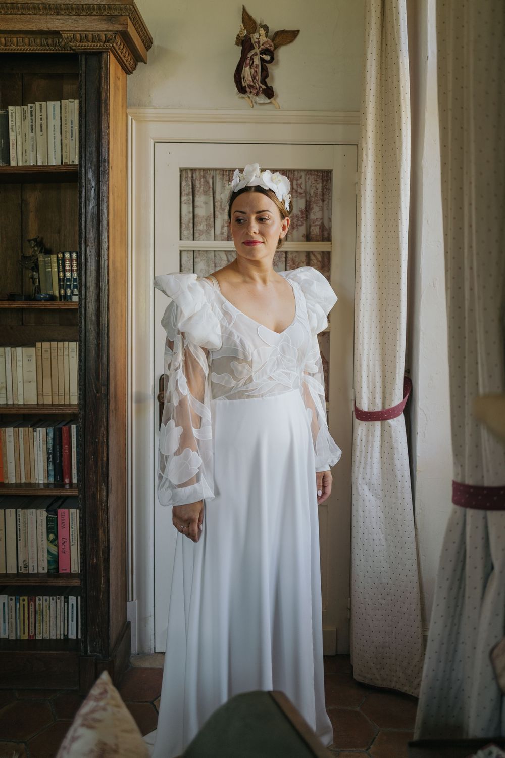 A sequence of photos showing a person in a flowing white vintage-style nightgown or dress standing in a room with bookshelves.