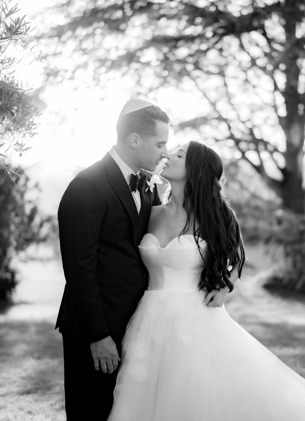 Ethereal black and white wedding portrait captured in dreamy natural light.