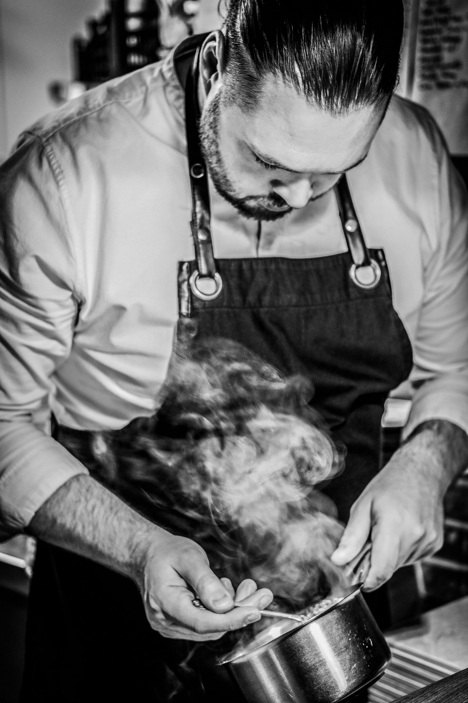 Chef Jono plating up a dish ready for service Photographed by Simon Robertson Photography