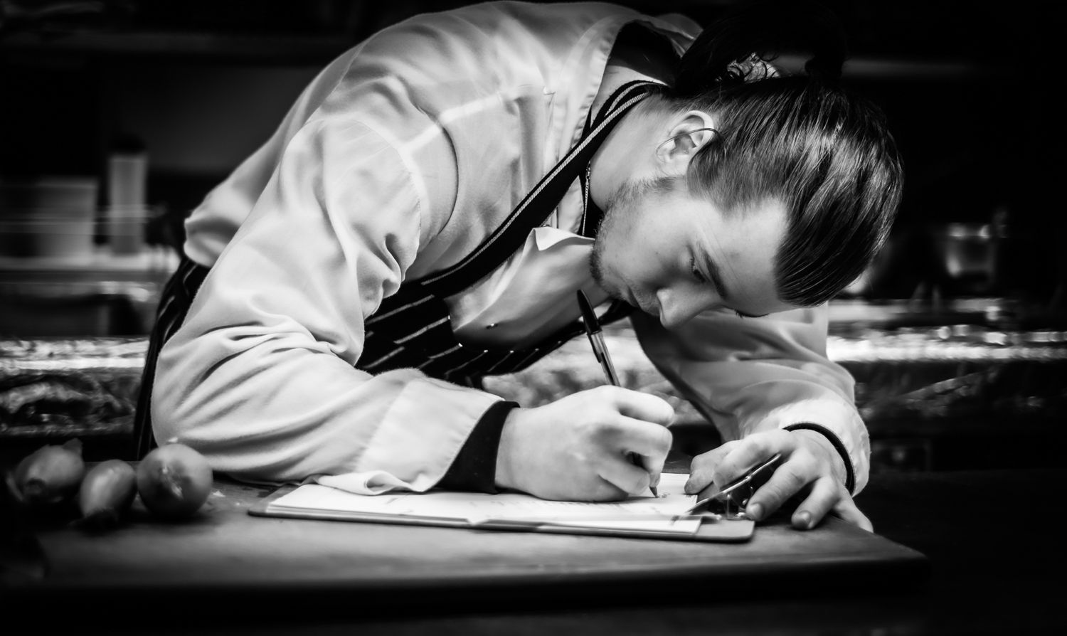 Chef preparing a list of orders for the kitchen Photographed by Simon Robertson Photography