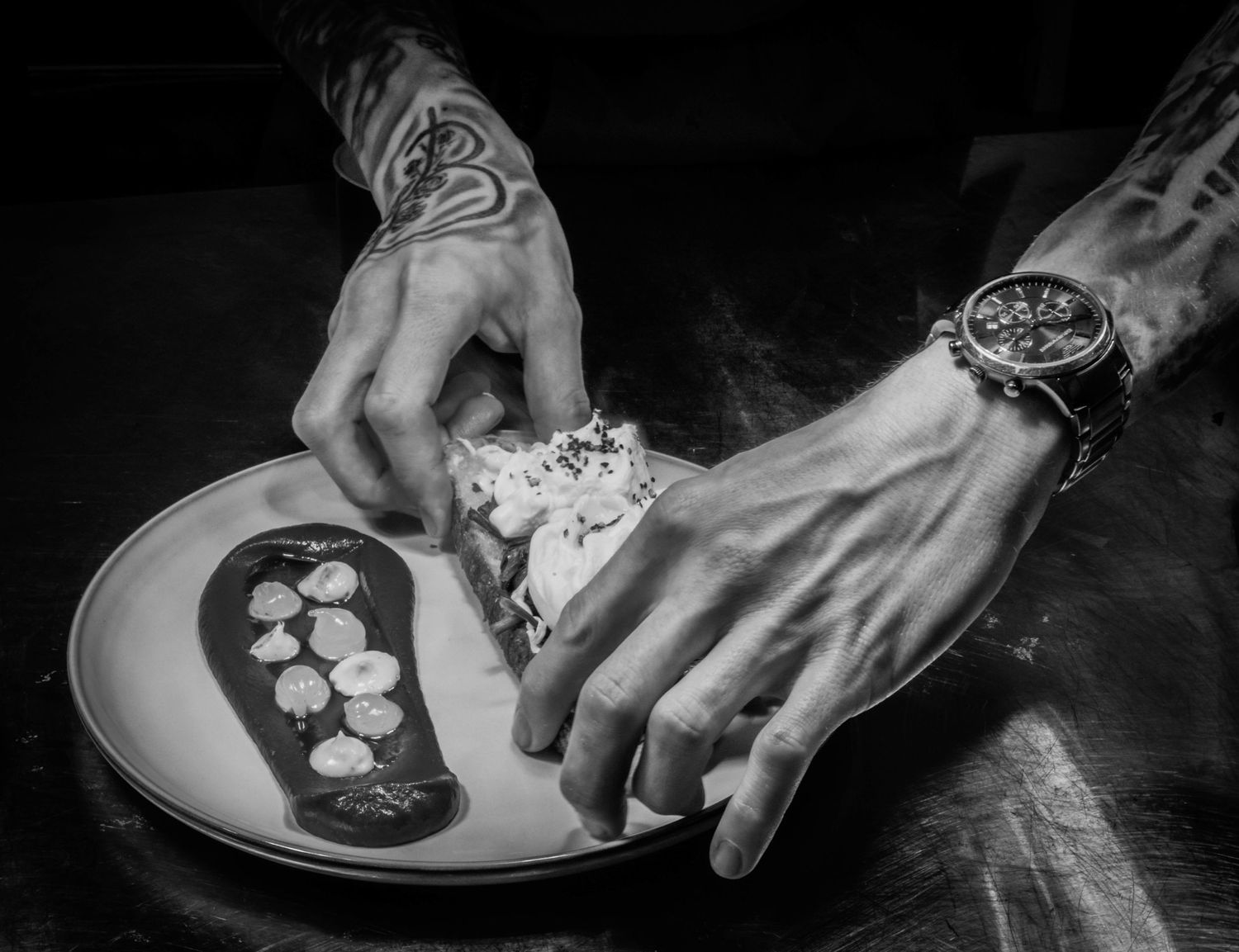 Chef Dale Spink plating up a dish ready for service Photographed by Simon Robertson Photography