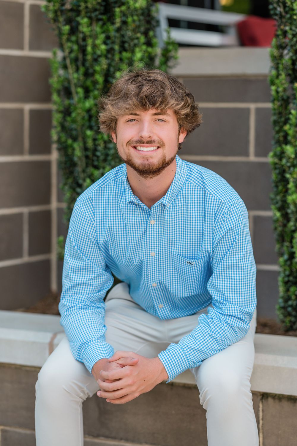 "High school senior boy photo session at Waverly shopping center, capturing youth and individuality."