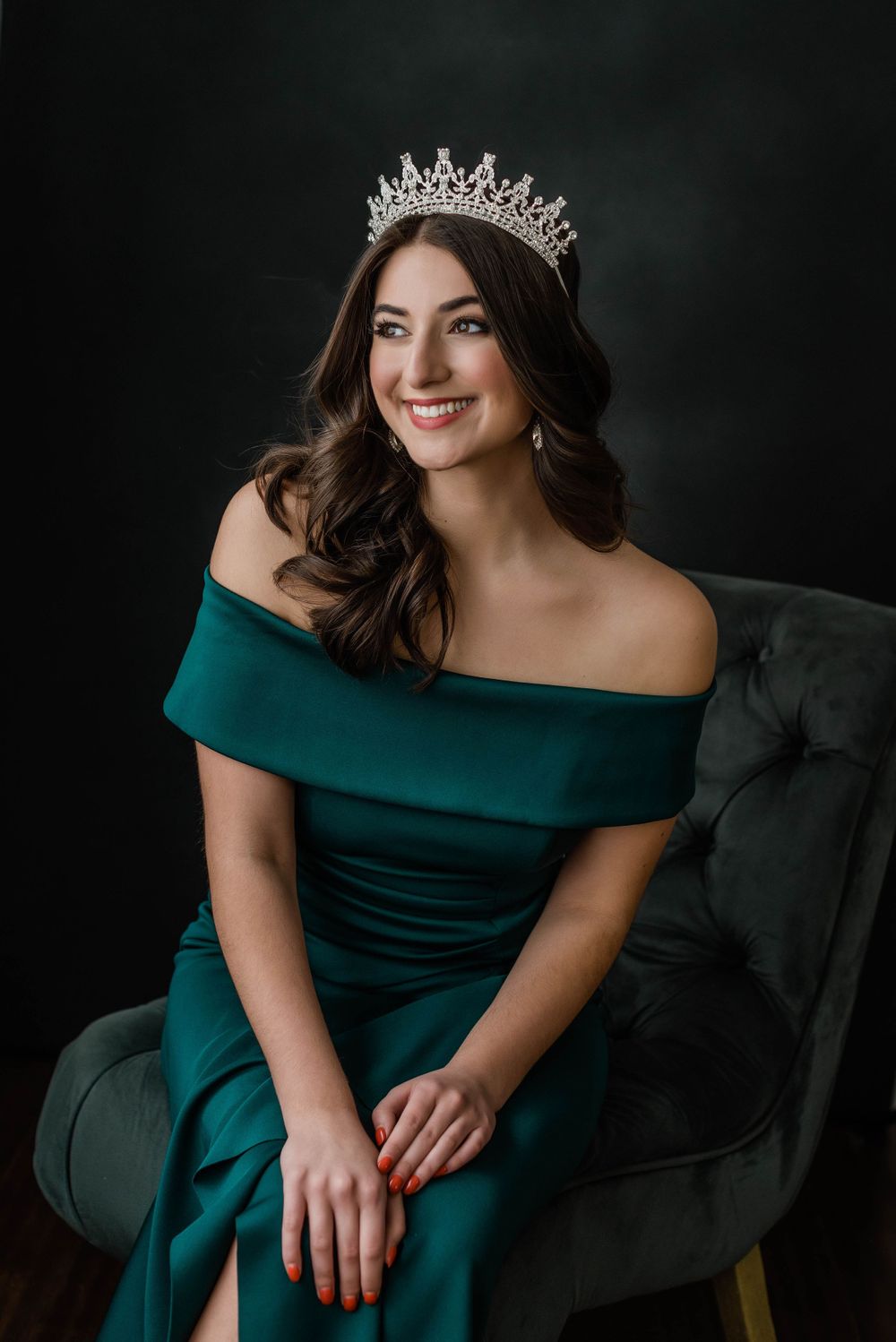 Senior portrait of a beauty pageant winner with her crown in studio.