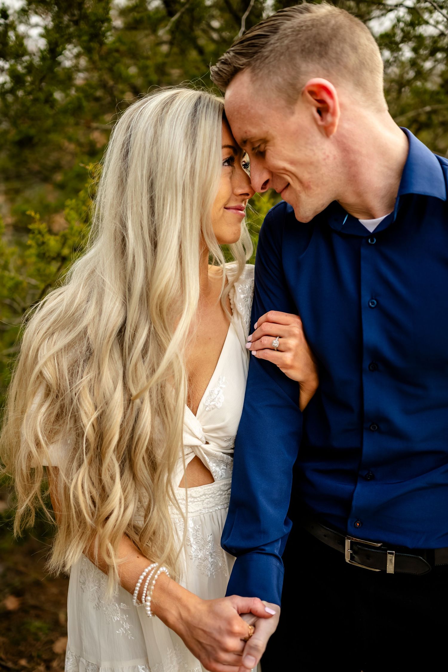 A romantic couple moment captured in soft natural lighting outdoors.