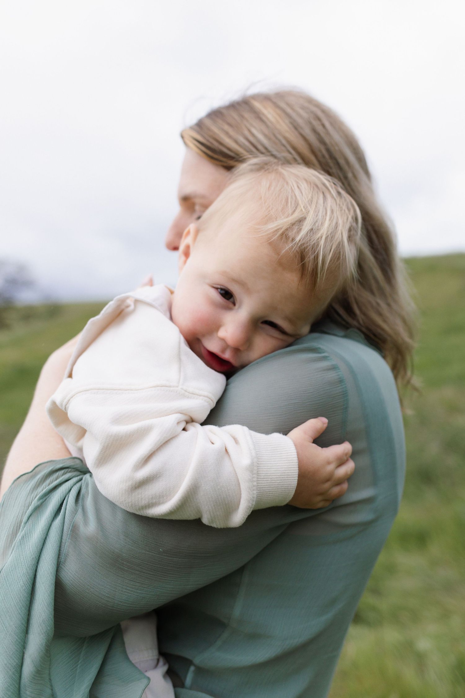 Son hugging his mom during a heartfelt family portrait session