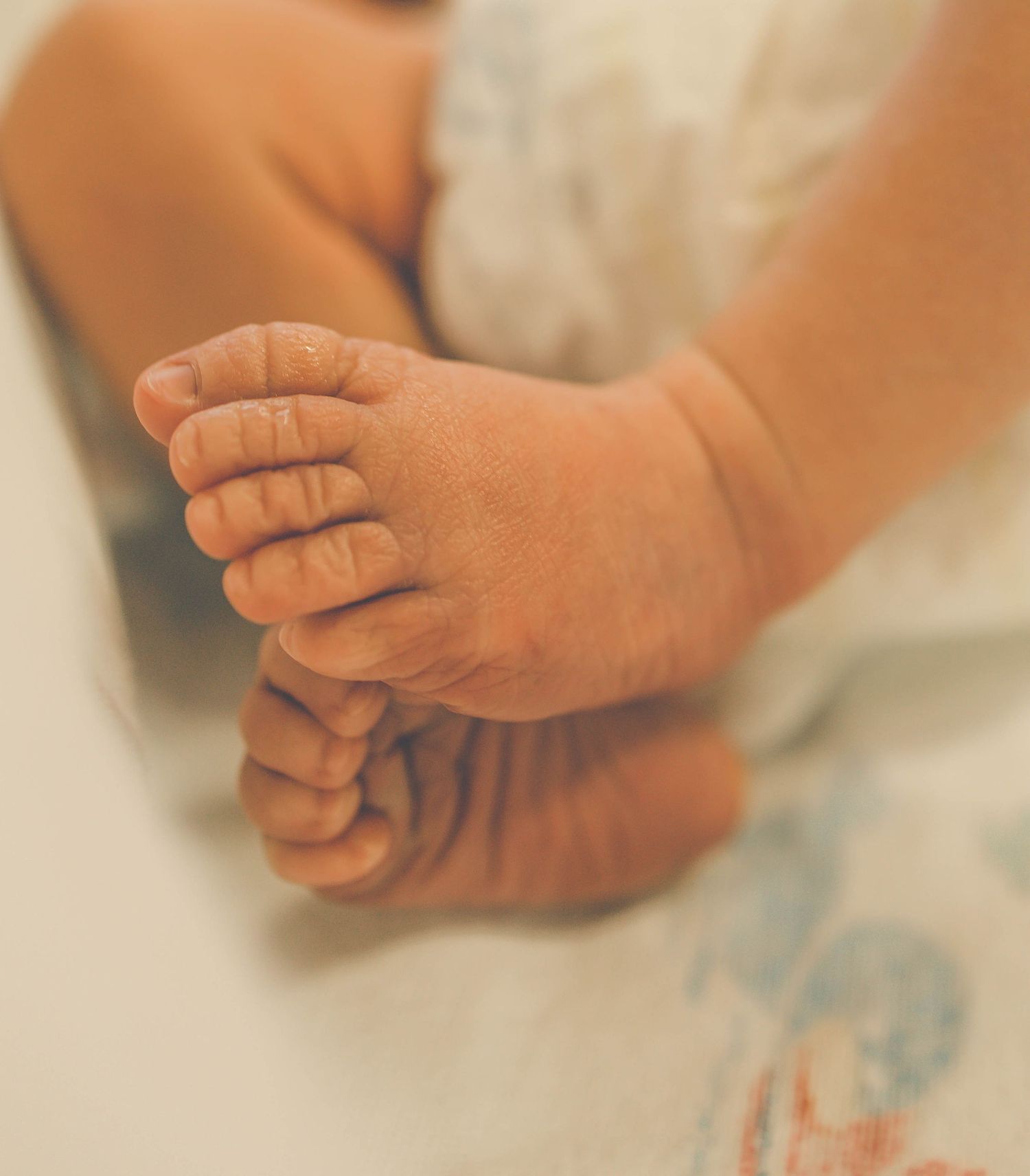 Close-up view of tiny baby feet with soft, gentle lighting.
