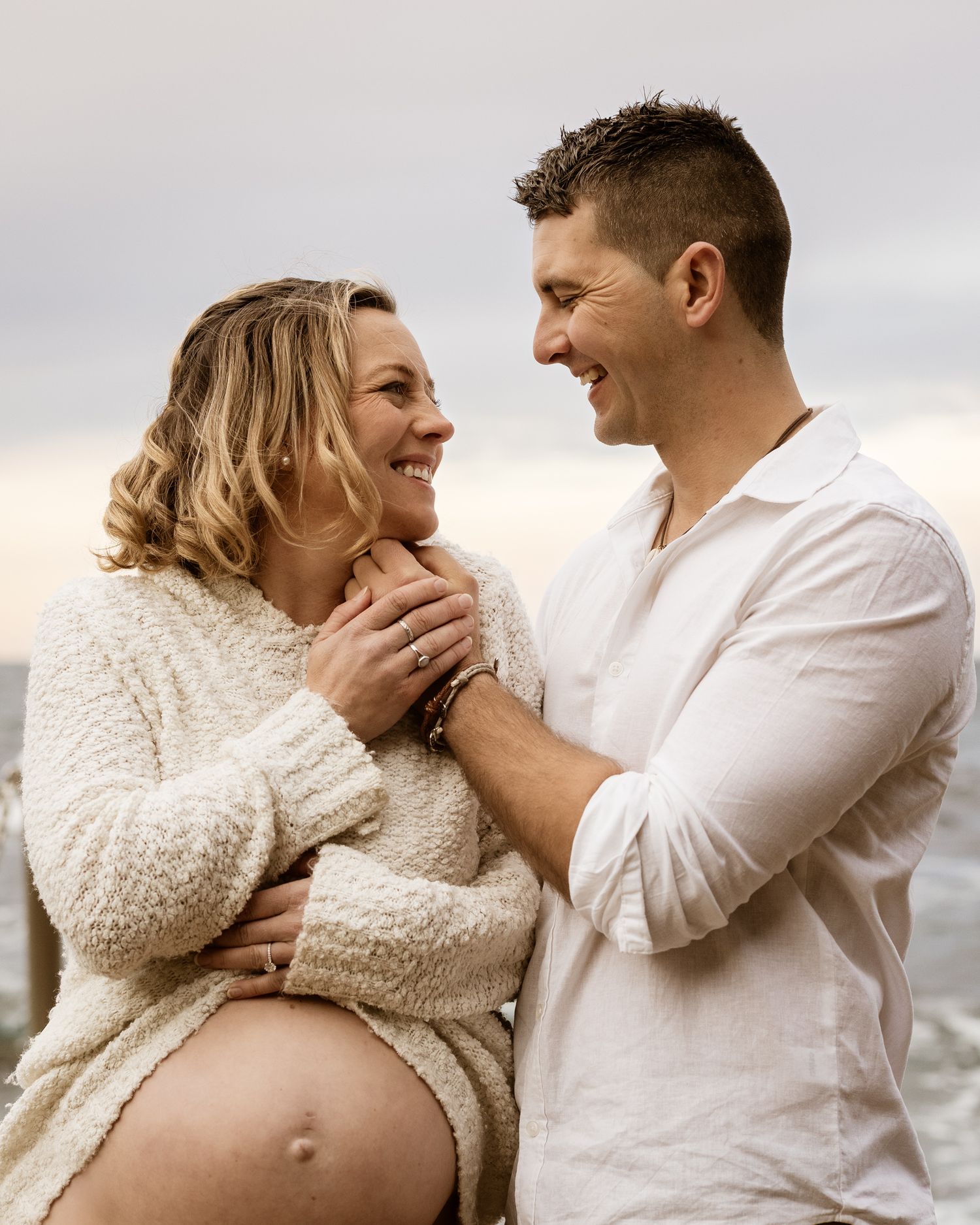 heartfelt maternity moment between couple in a quiet Sydney beach