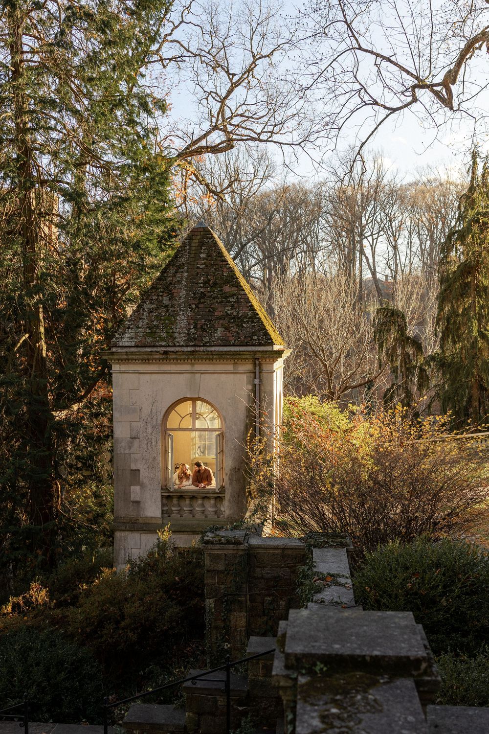 Stone gazebo structures in a wooded garden setting captured at different angles in autumn light.