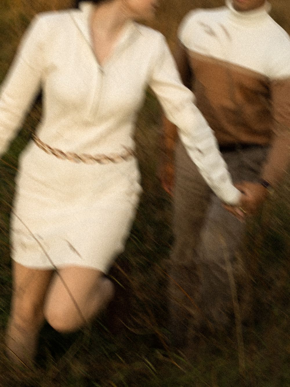 A series of blurred motion photographs showing someone in a white dress spinning or dancing against a dark background.