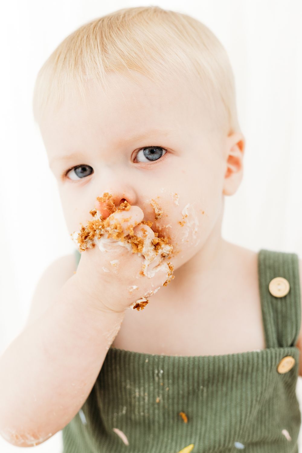 Nottingham first birthday cake smash photoshoot with baby in minimal neutral setup, timeless portraits at Mapperley studio.