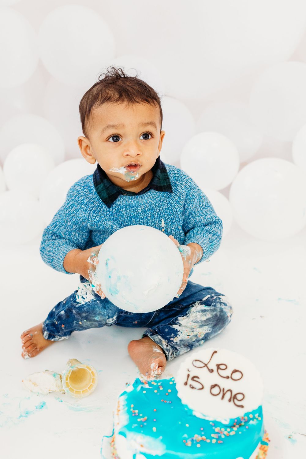 Baby enjoying their first birthday cake smash.