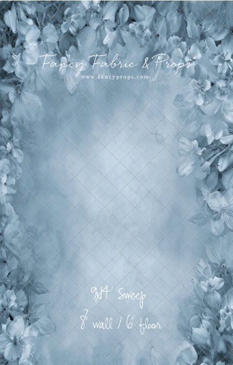 Soft blue floral background design with delicate leaves and flowers creating an ethereal frame around the edges.