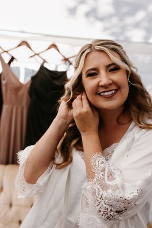 A getting ready moment shows wedding preparation with dresses hanging in the background.