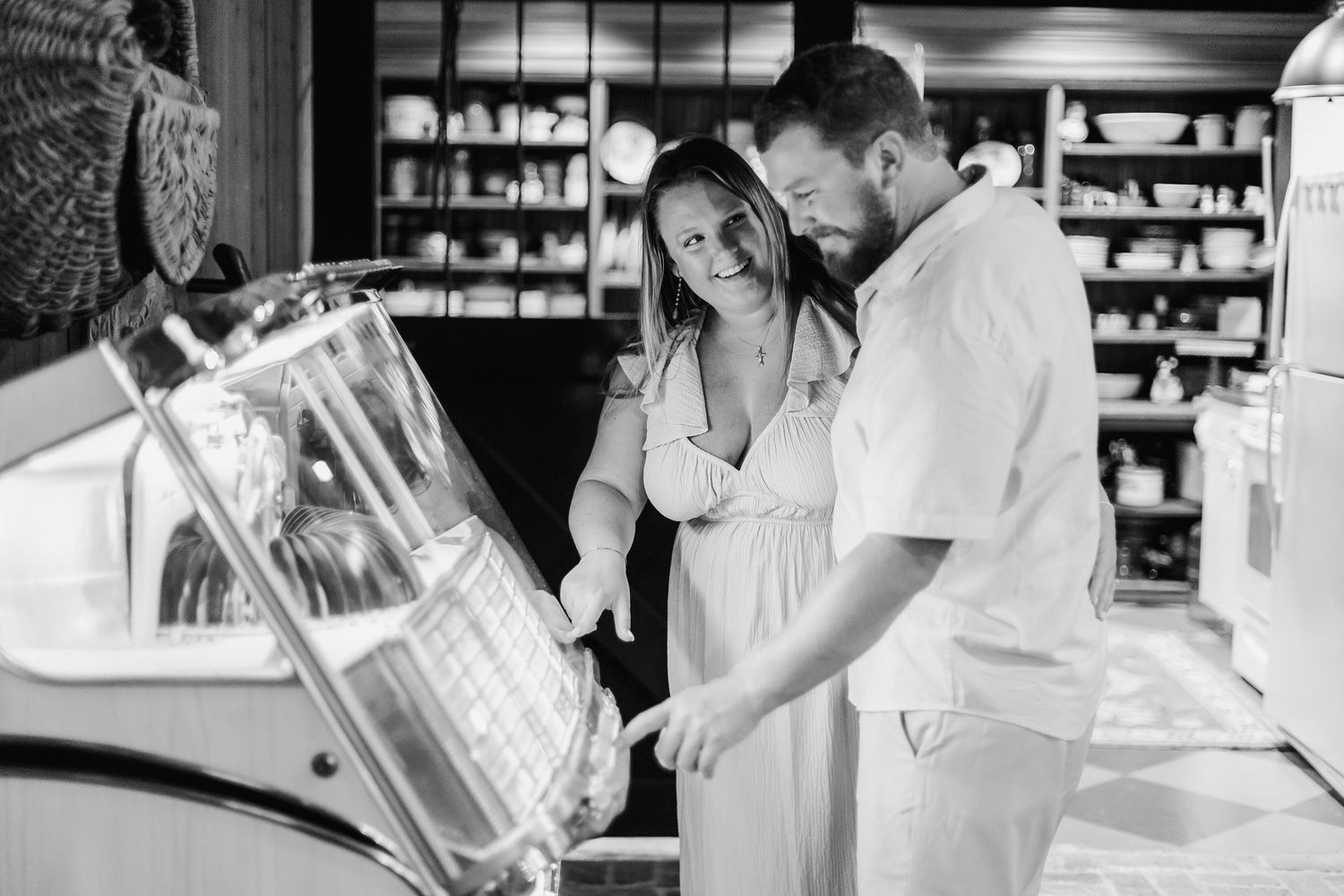 Black and white photo series showing wedding preparations with bridesmaids helping with dress details.