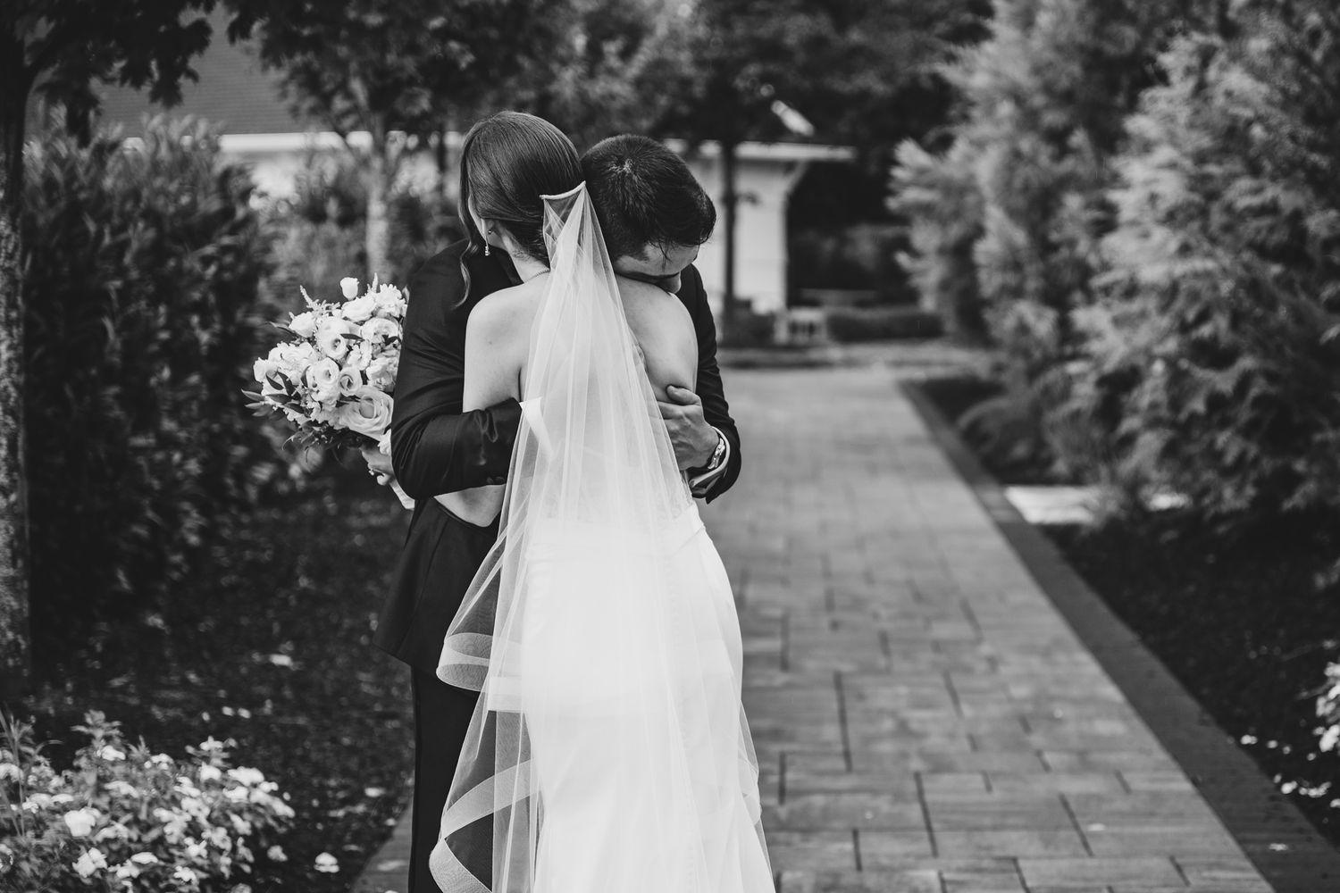 Black and white wedding photos show romantic moments at edgewood country club elegant floral arrangements during first look
