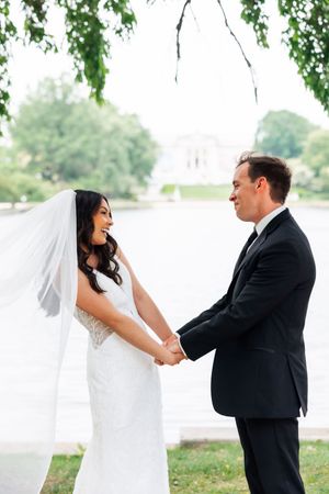 Wedding couple shares playful moments in a sequence of photos by a lakeside with green trees overhead.