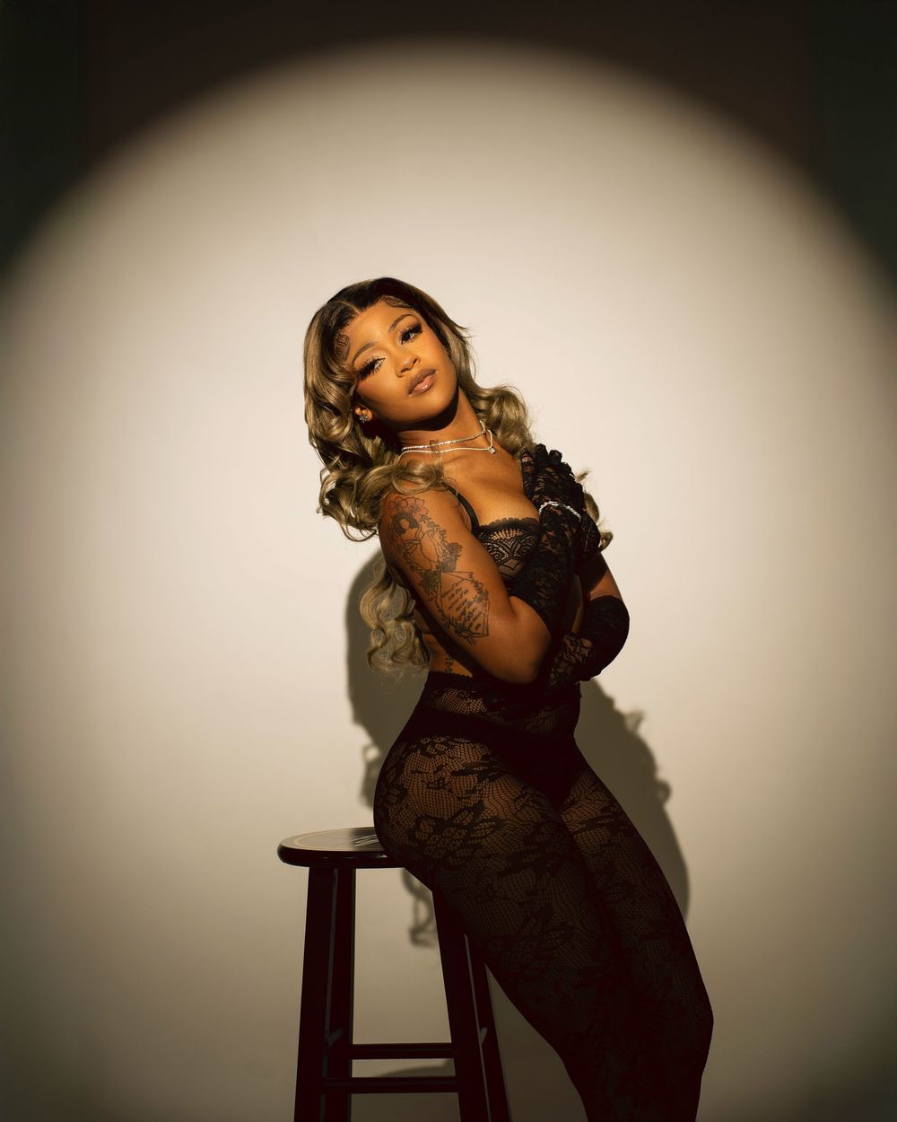 Artistic portrait series showing dramatic lighting and poses against a dark background with vignette effect.