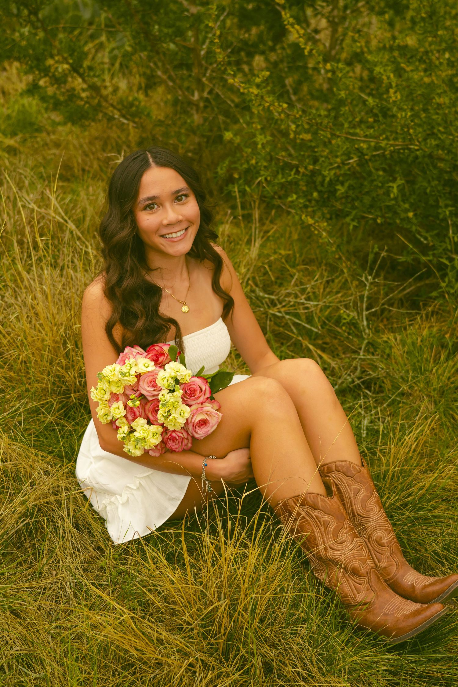 Person in white dress walking through field during golden hour.
