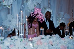 A wedding celebration with guests enjoying themselves at a reception decorated in soft blue and pink tones.