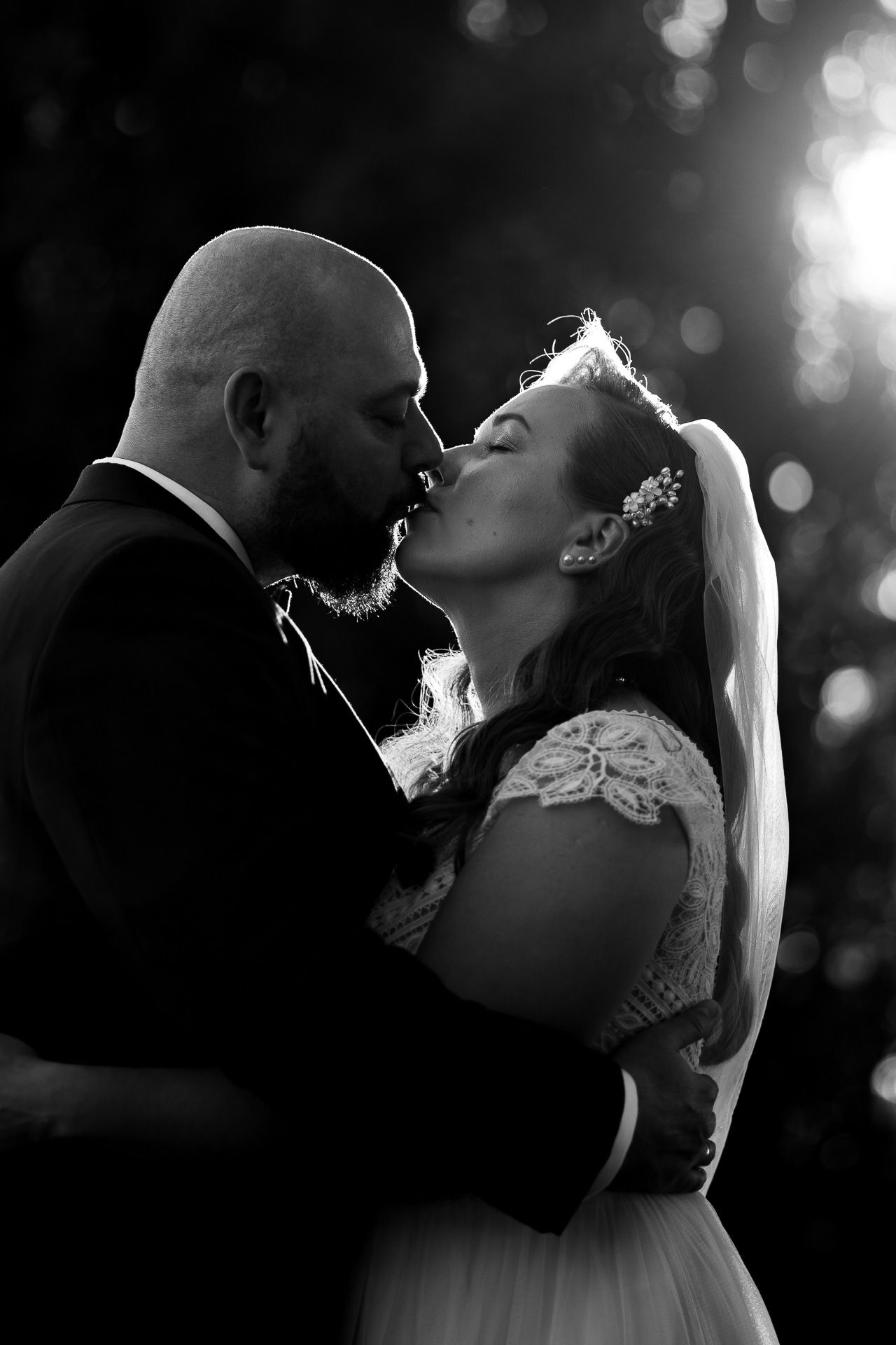 Artistic black and white silhouettes of newlyweds sharing romantic moments.