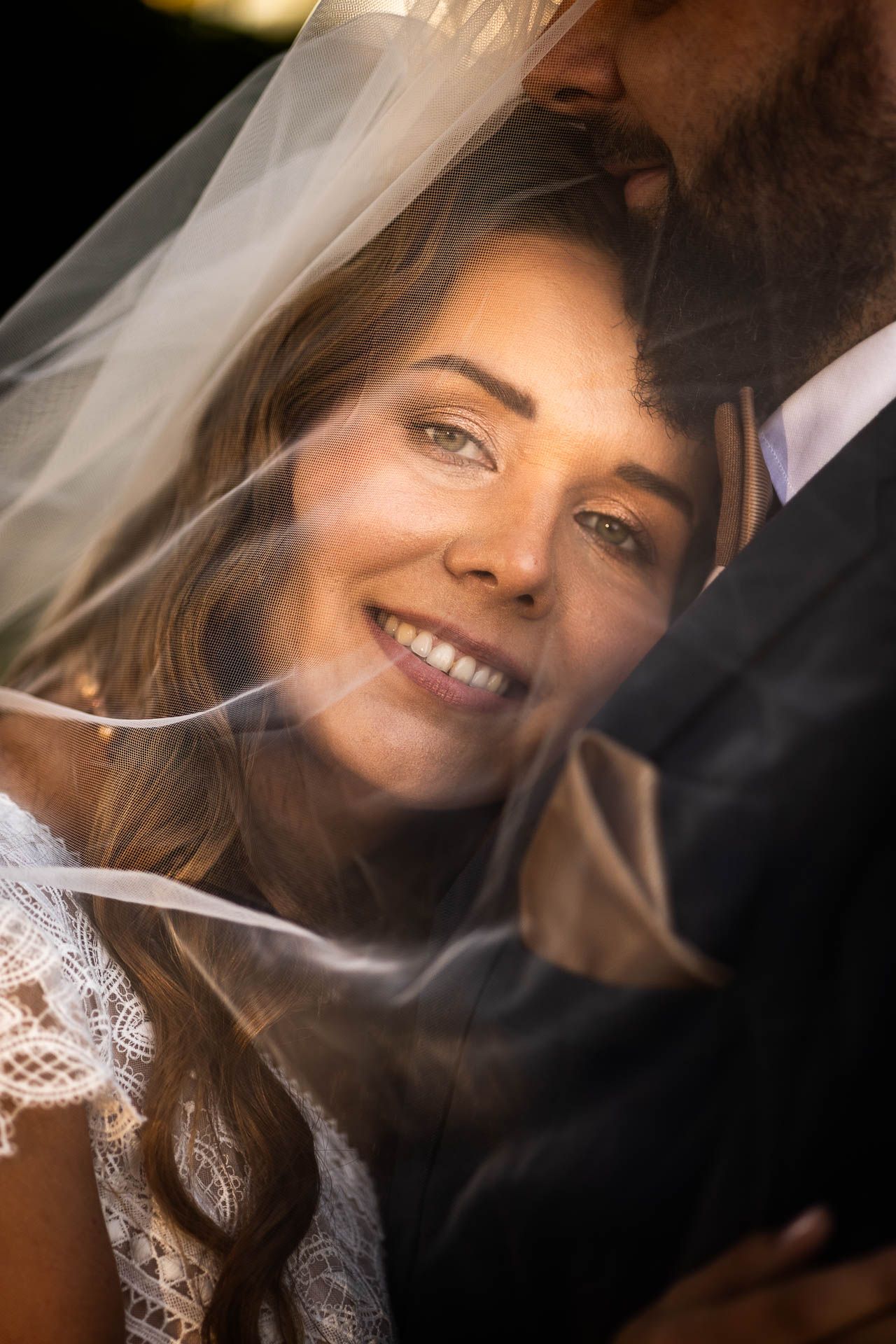 Close-up wedding portrait with delicate veil and natural light.