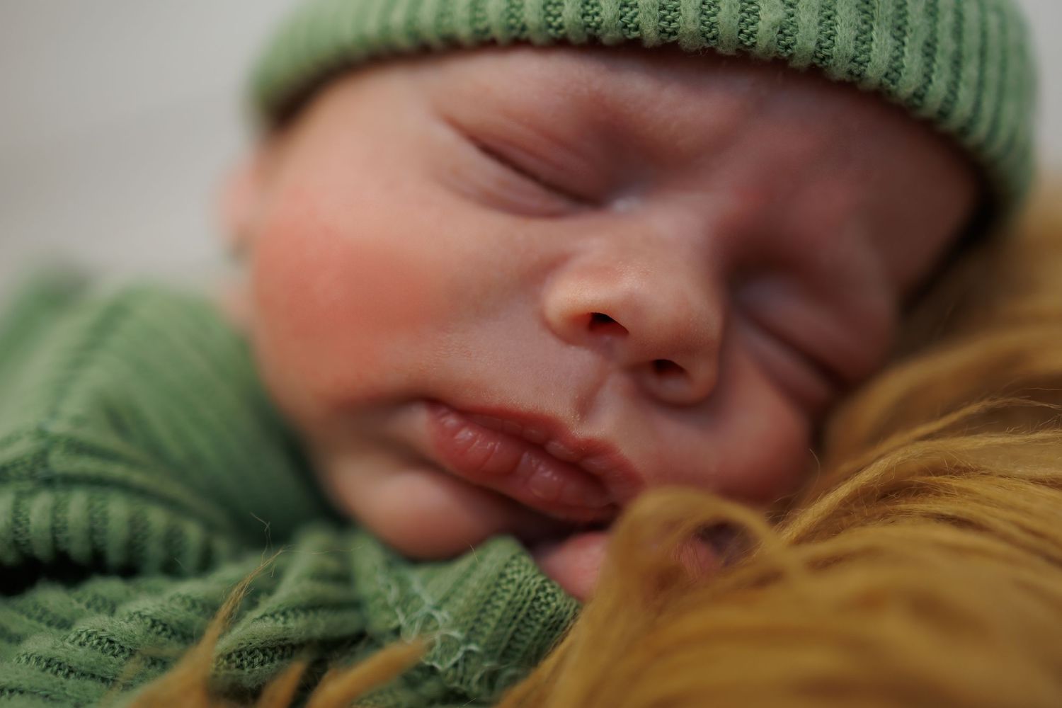 Close up detail of newborn baby during a twin newborn photography session in Michigan