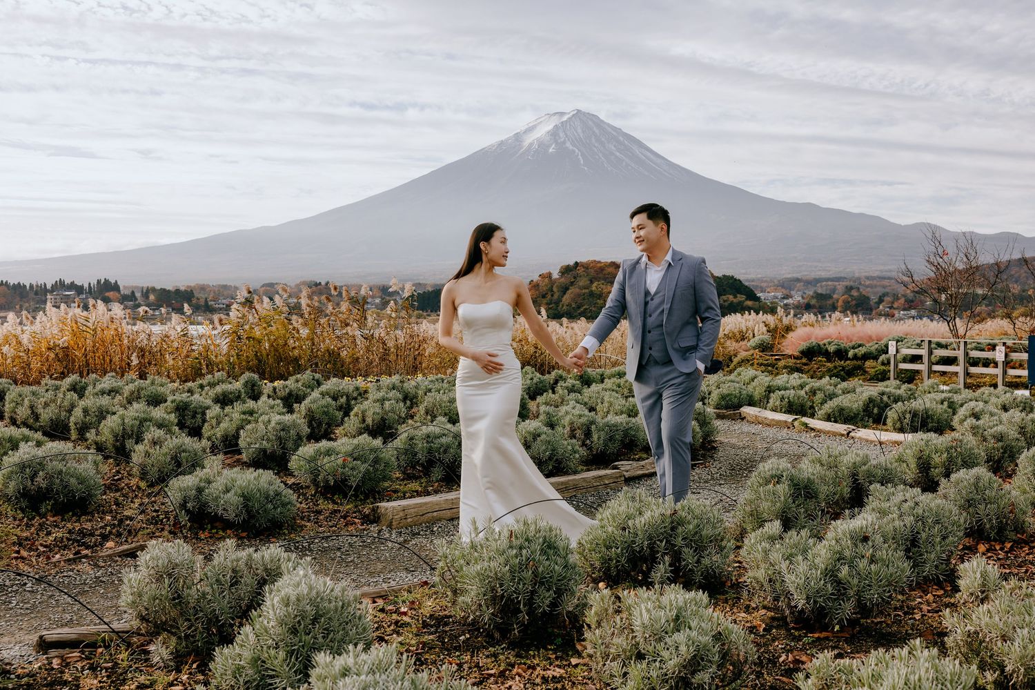 A couple shares a romantic moment in front of Mount Teide in Tenerife during golden hour.