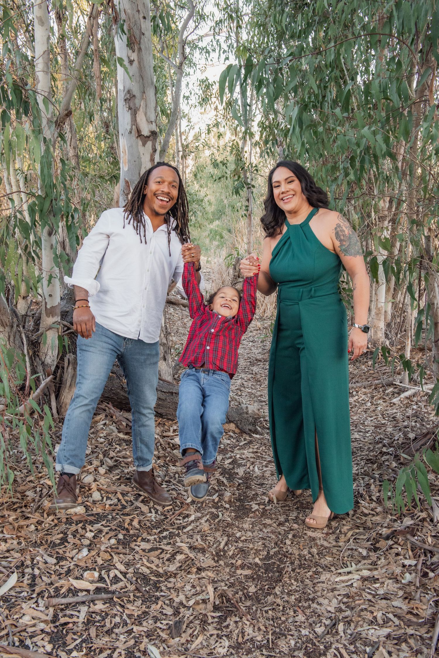 Three playful photos in a forest setting show casual poses among eucalyptus trees with fallen leaves on the ground.