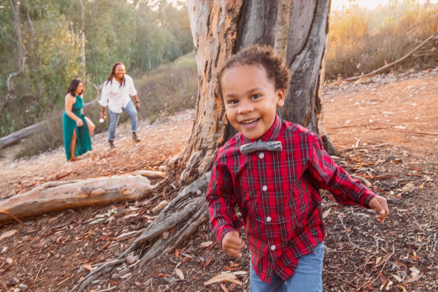 A group enjoying a nature walk together on a wooded trail during golden hour.