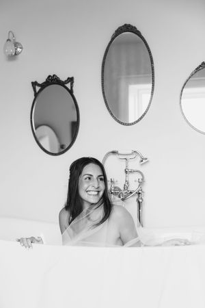 Black and white series of decorative mirrors on a white wall with elegant vintage frames.