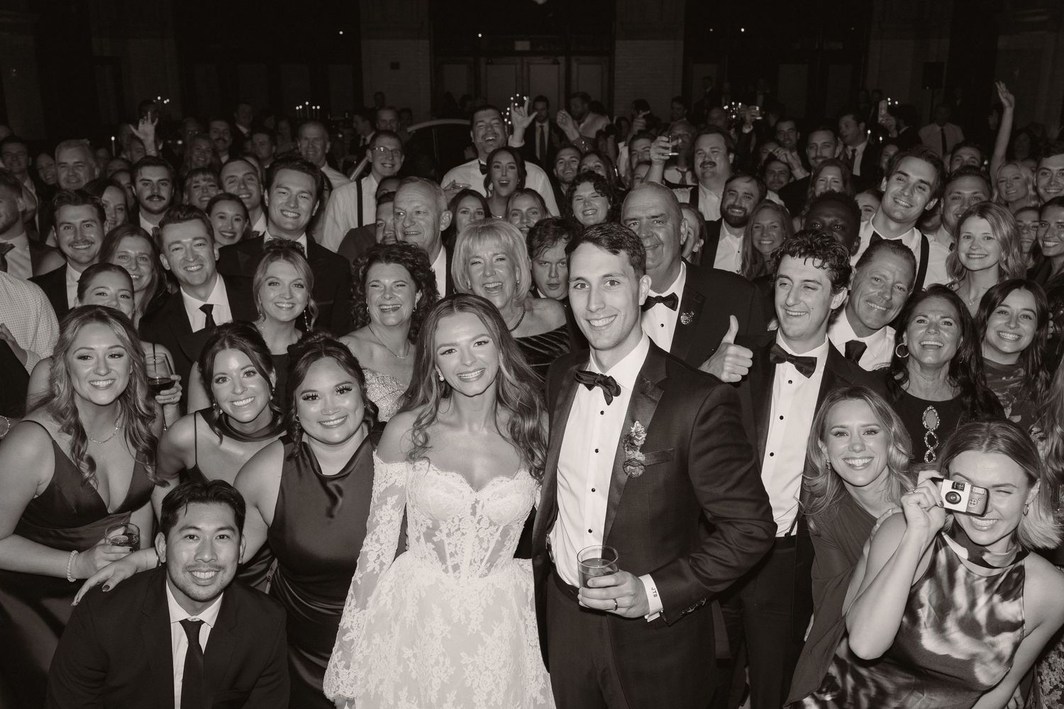 A collage of black and white photos showing wedding guests celebrating and dancing at a formal reception.