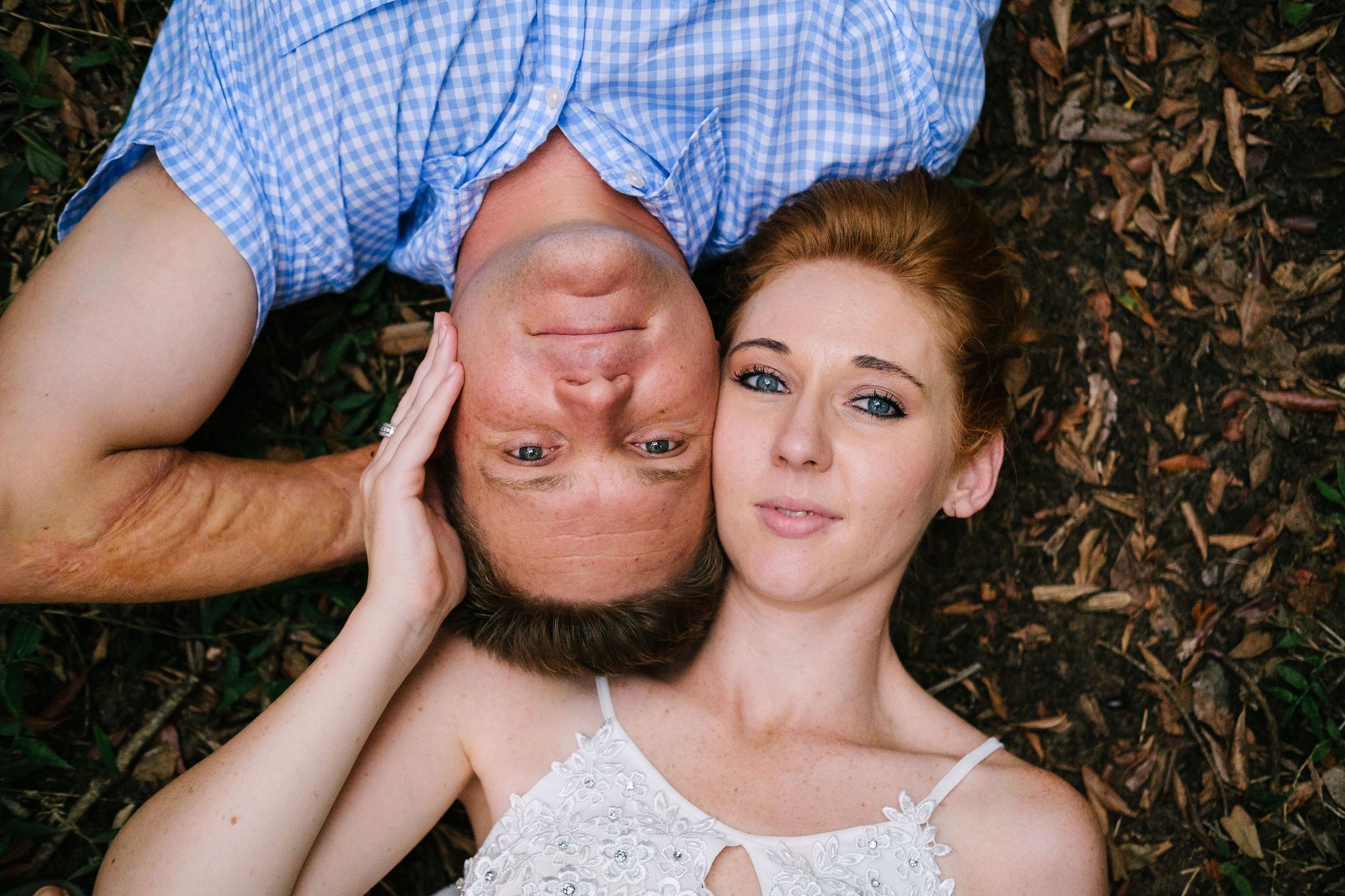 Couple lying together on the ground during a relaxed outdoor portrait session
