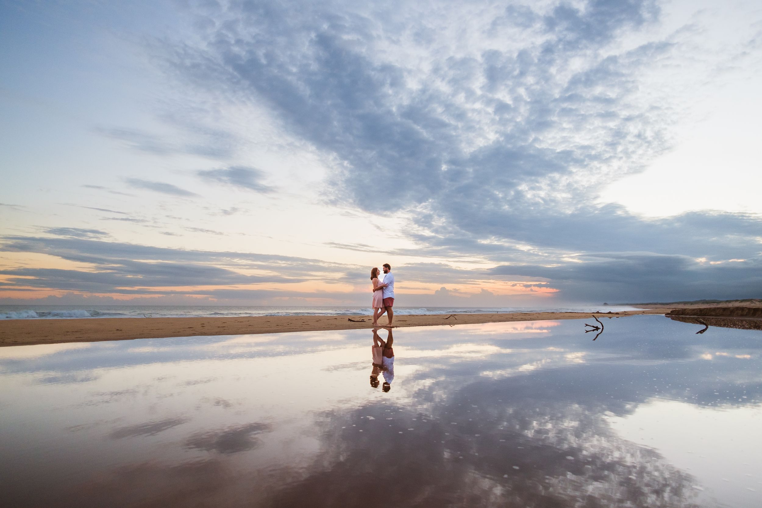 Couple photoshoot at Mtunzini Beach with reflections, sky, and sea