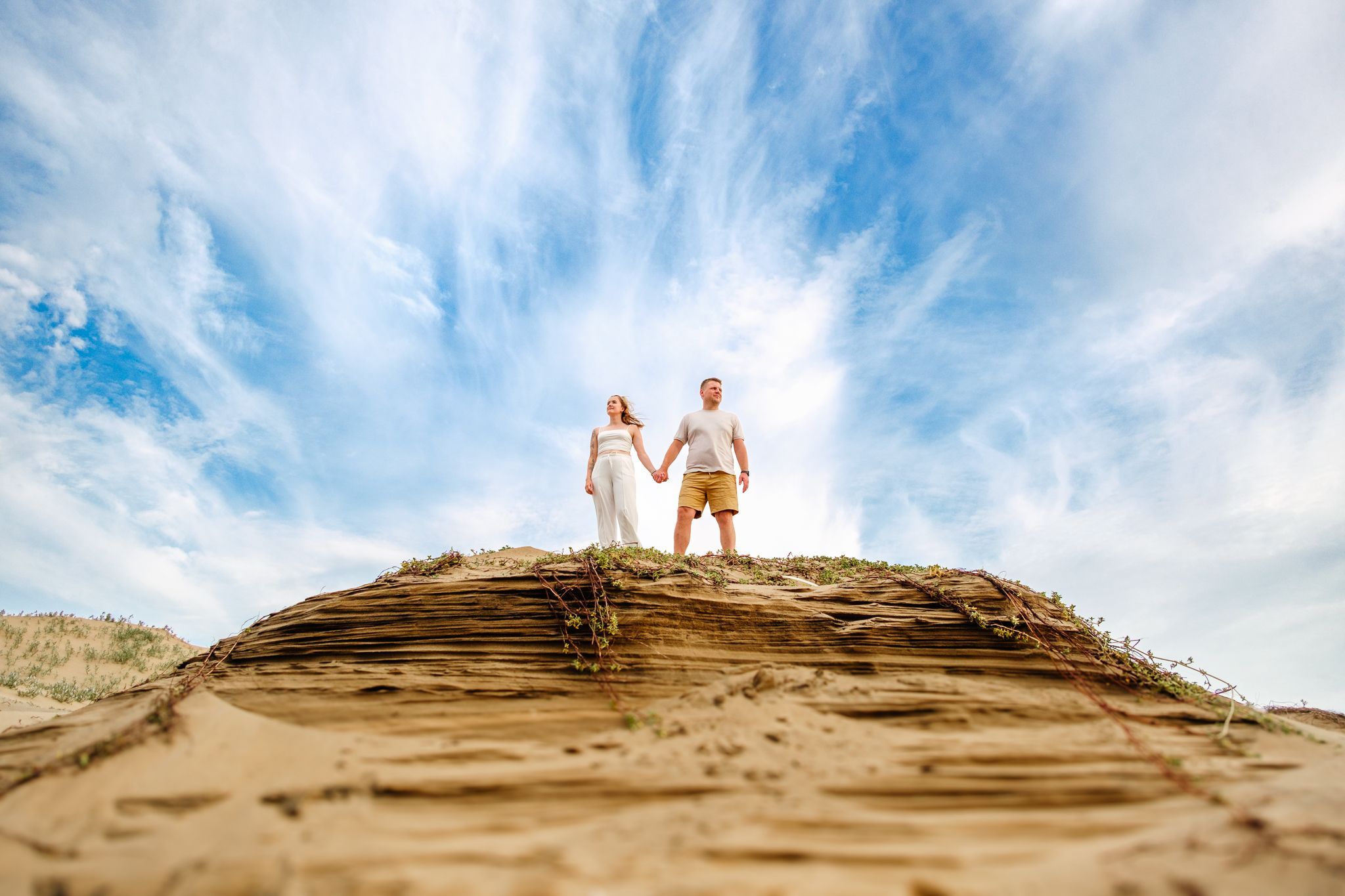 Couple standing on a dune at Mtunzini Beach with a dramatic sky backdrop