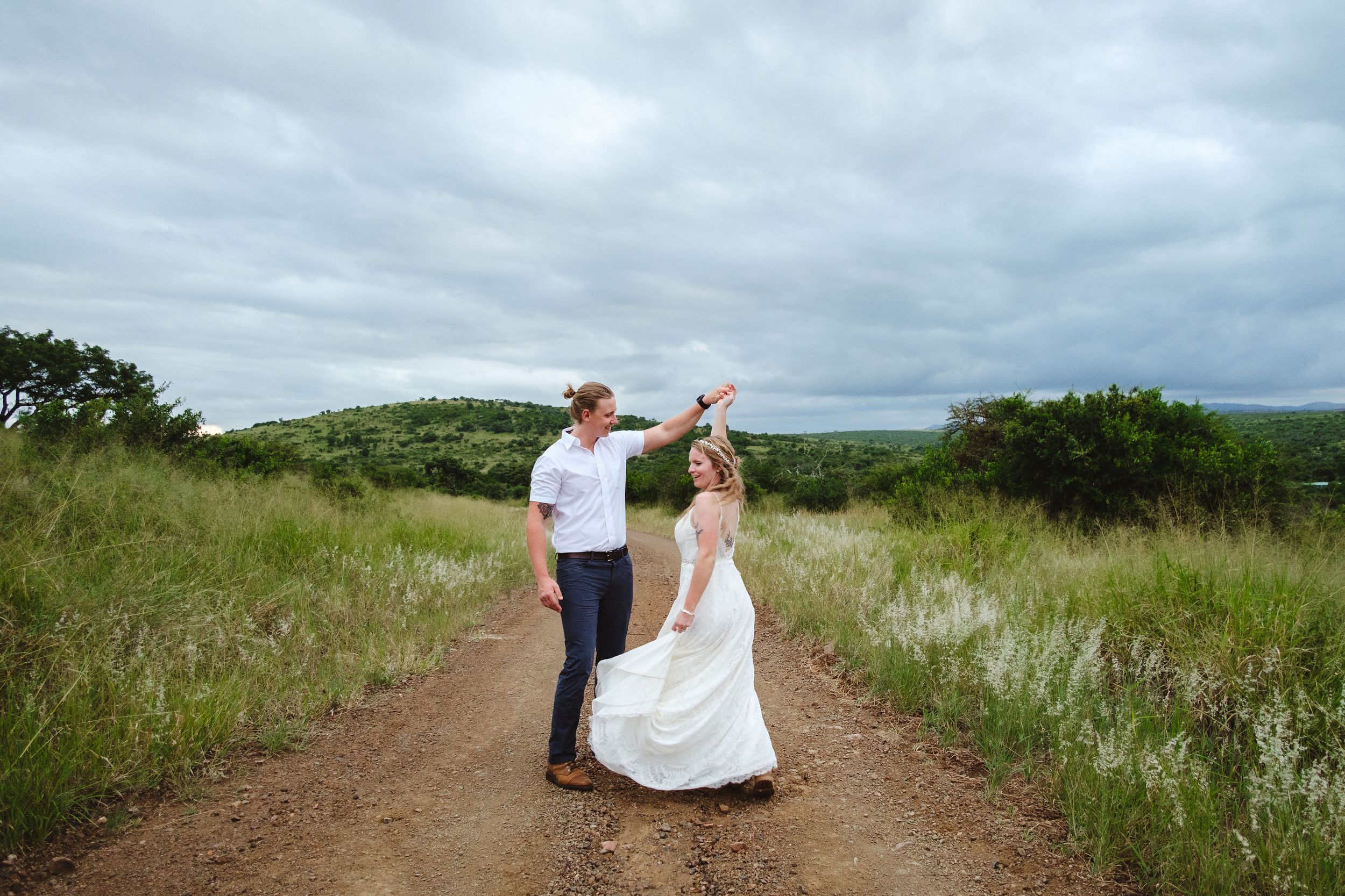 Elopement couple dancing together on a quiet dirt road